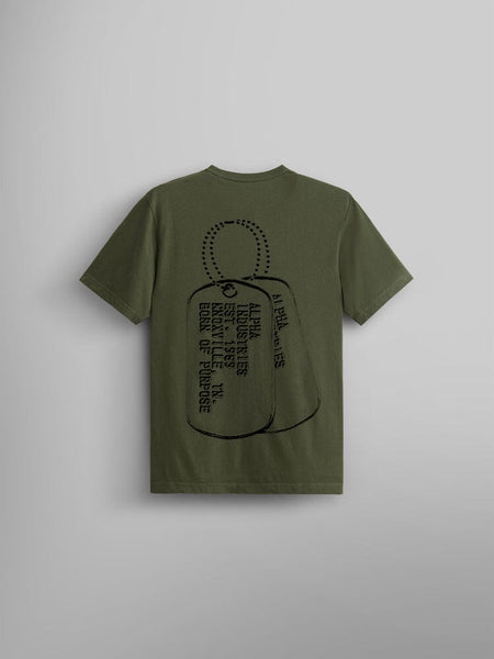 The Alpha Dog Tag Tee by Alpha Industries, is a unisex olive green T-shirt that prominently showcases a large screen print graphic of military dog tags.