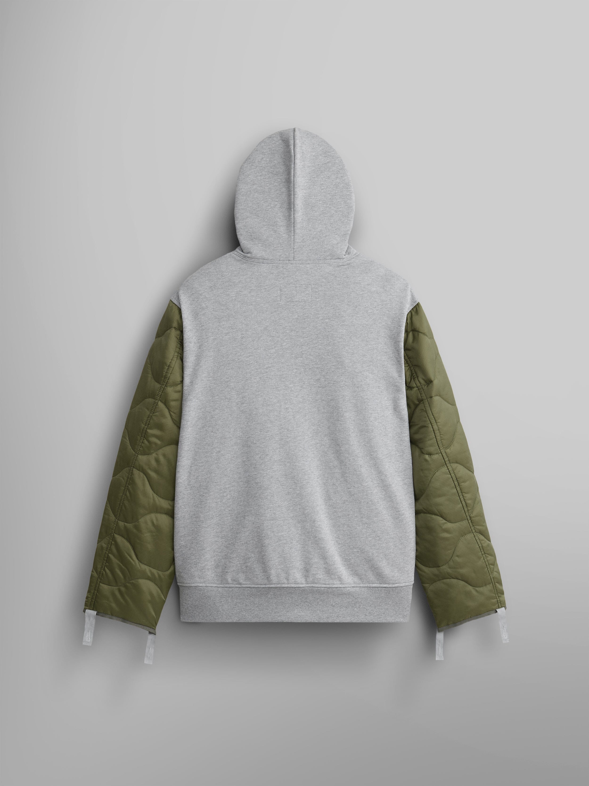 The ALS/92 Quilted Liner Hoodie by Alpha Industries showcases a unisex style with striking onion quilting on its green sleeves, displayed from the back.