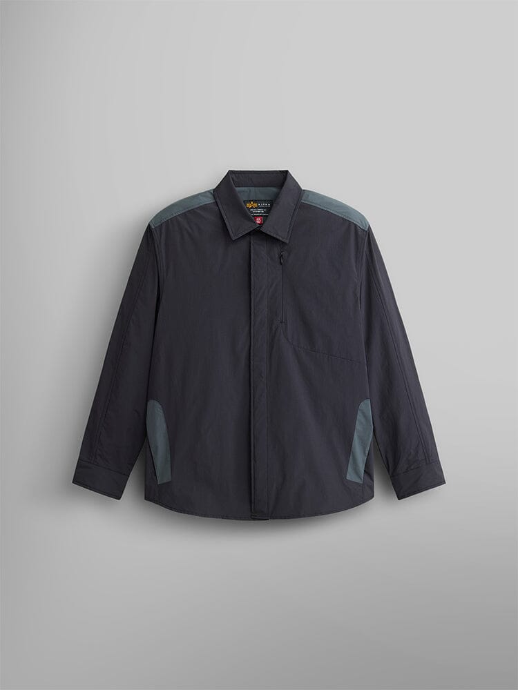 The Astral Shirt Jacket by Alpha Industries features a black design with a point collar and button closure. It includes contrasting lighter gray accents on the shoulders and pockets.