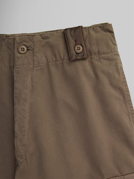 Close-up of the Belgian M-64 Pant in brown by Alpha Industries. Featuring a buttoned strap at the waistband.