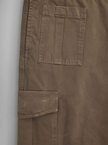 Close-up of the Belgian M-64 Pant in brown by Alpha Industries, featuring two pockets, one with a flap, and visible stitching detail.