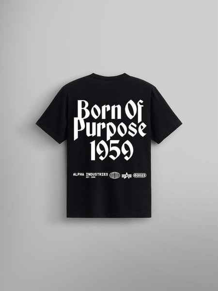 The back of the Born Of Purpose Tee by Alpha Industries is a unisex black t-shirt. It features white screen-printed text reading "Born of Purpose 1959" along with logos, including the iconic Flying A logo.