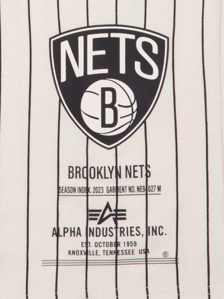 Close-up of the Brooklyn Nets x Alpha Industries x New Era Tee, showcasing the team's logo and text, embodying NBA spirit alongside Alpha Industries. Established in October 1959 in Knoxville, Tennessee, USA, this tee perfectly blends sports heritage and style, reminiscent of an iconic bomber jacket design.