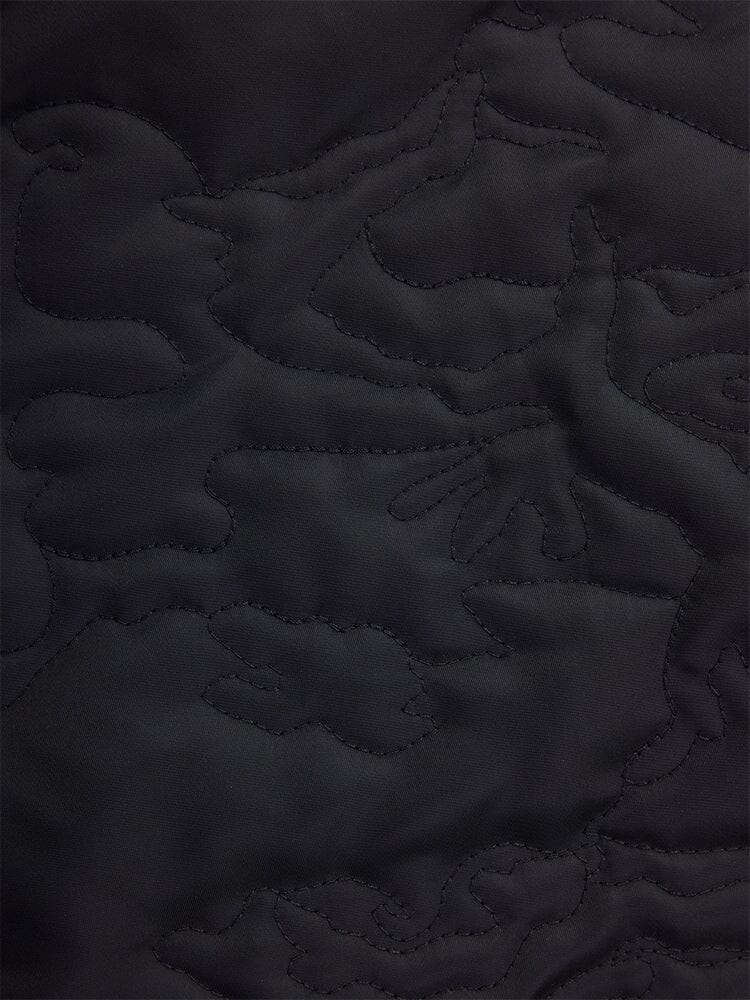 Close-up of fabric from the Alpha Industries Camo Quilted MA-1 Bomber Jacket, showcasing a black quilted camo pattern with an abstract design.