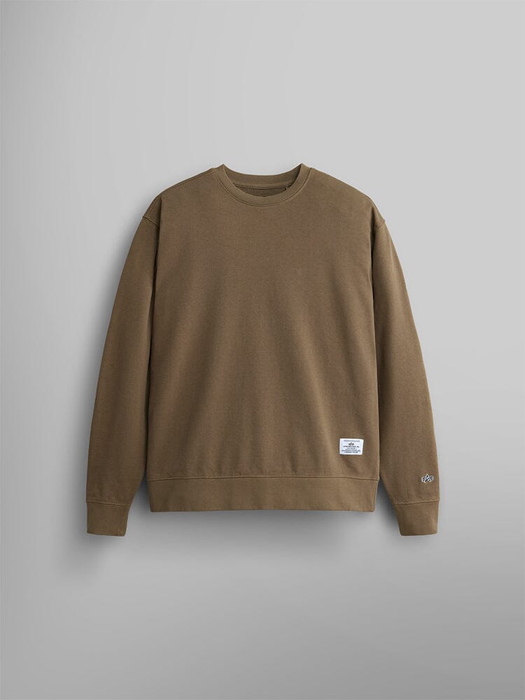 The Essential Crewneck by Alpha Industries is a unisex sweatshirt in coyote brown, crafted from a cozy cotton blend. It features a small white label on the lower front that emphasizes its timeless style.