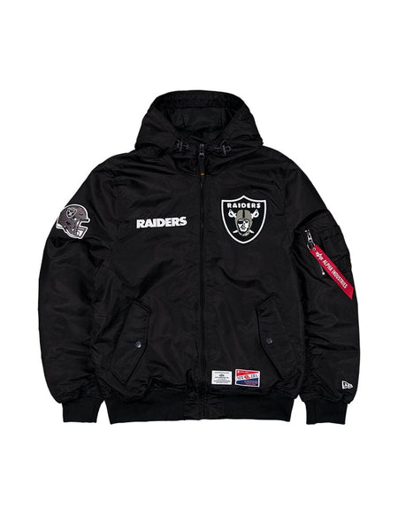 The Las Vegas Raiders X Alpha X New Era L-2B Bomber Jacket by Alpha Industries features a black hood with the Las Vegas Raiders team logo and patch on the front, a side pocket adorned with a red tag, and snap buttons.