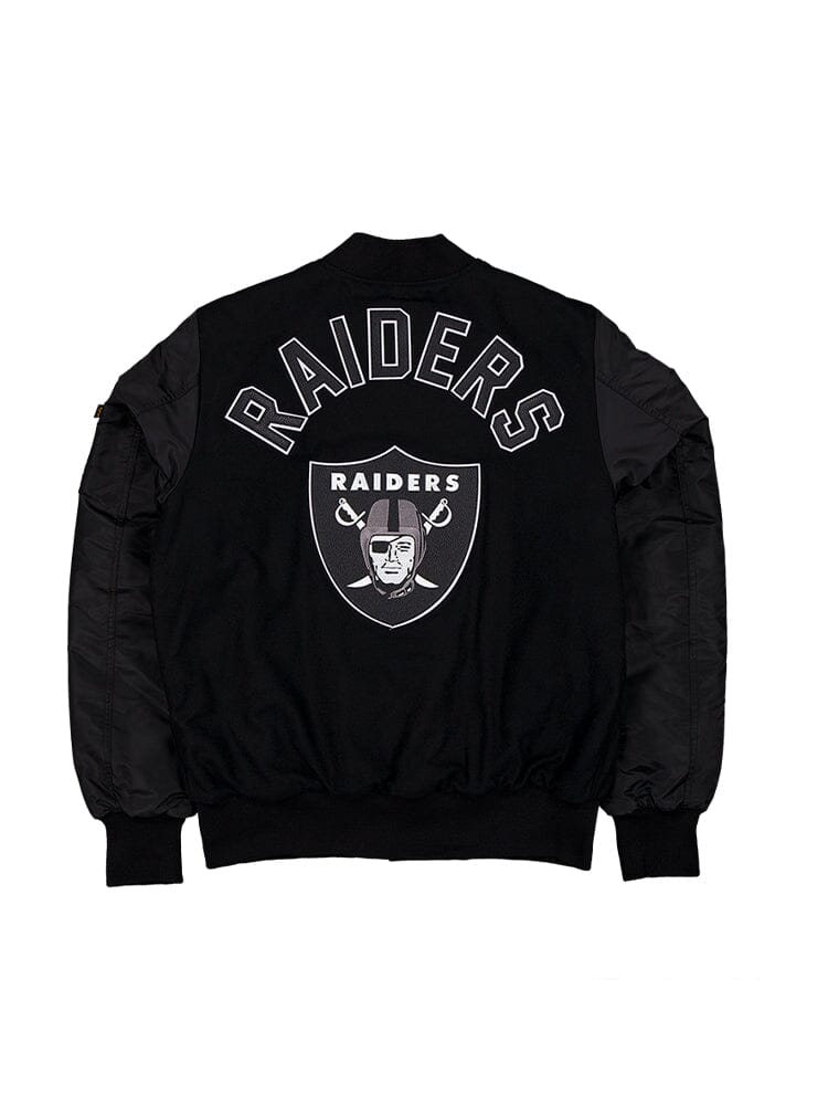 The Las Vegas Raiders X Alpha X New Era MA-1 Bomber Jacket from Alpha Industries features a wool outer shell and prominently displays the Raiders name alongside their iconic logo of a helmeted figure with crossed swords on the back. Authentic team patches complete this standout garment.