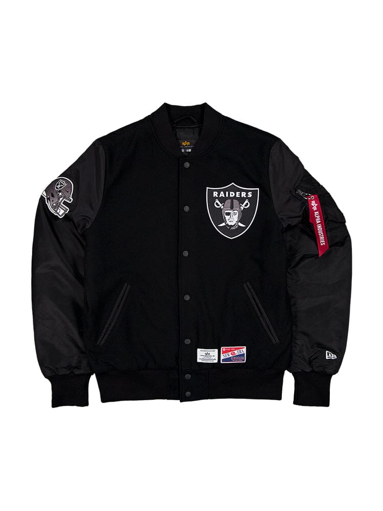 The Las Vegas Raiders X Alpha X New Era MA-1 Bomber Jacket, crafted by Alpha Industries, boasts a wool outer shell in black, adorned with striking logos on the chest and sleeve. This NFL bomber jacket features practical pockets and a button-up front, enhanced with team patches to make it an essential standout piece in any fan's wardrobe.