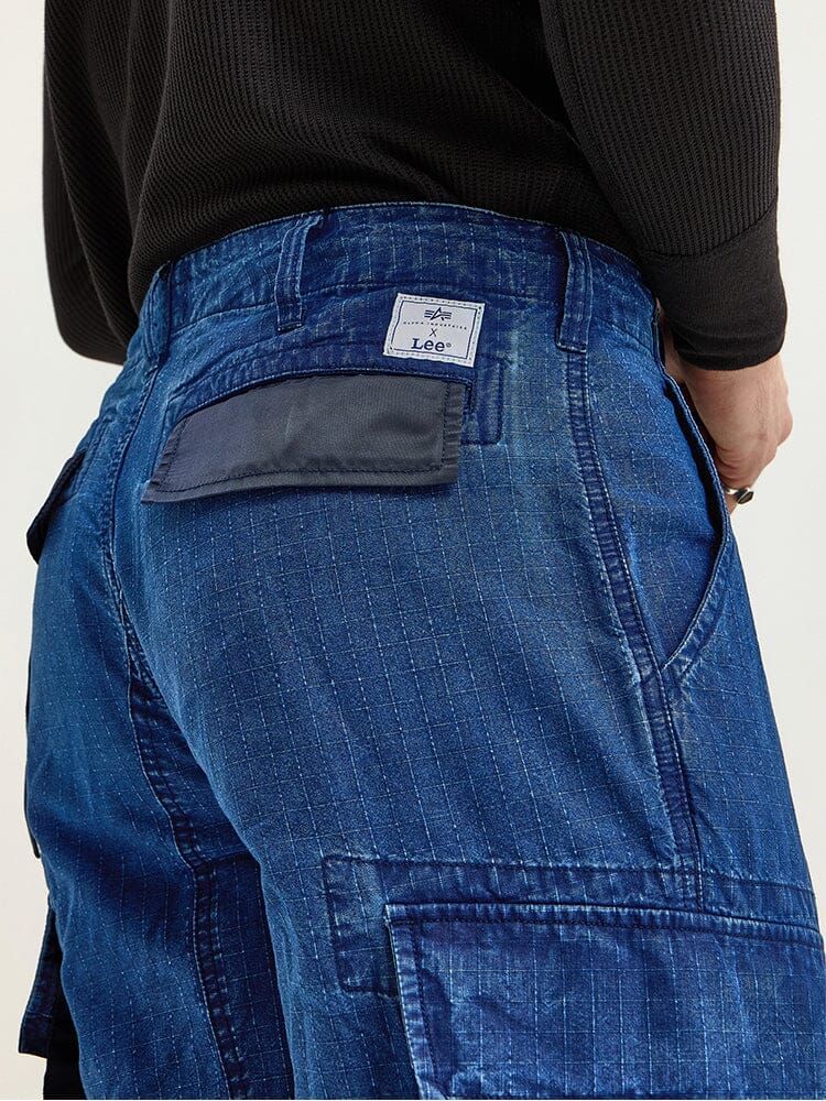 The individual sported the Alpha X Lee ACU Pant with a military design in blue denim and a black shirt, proudly displaying the Lee brand label on the waistband.