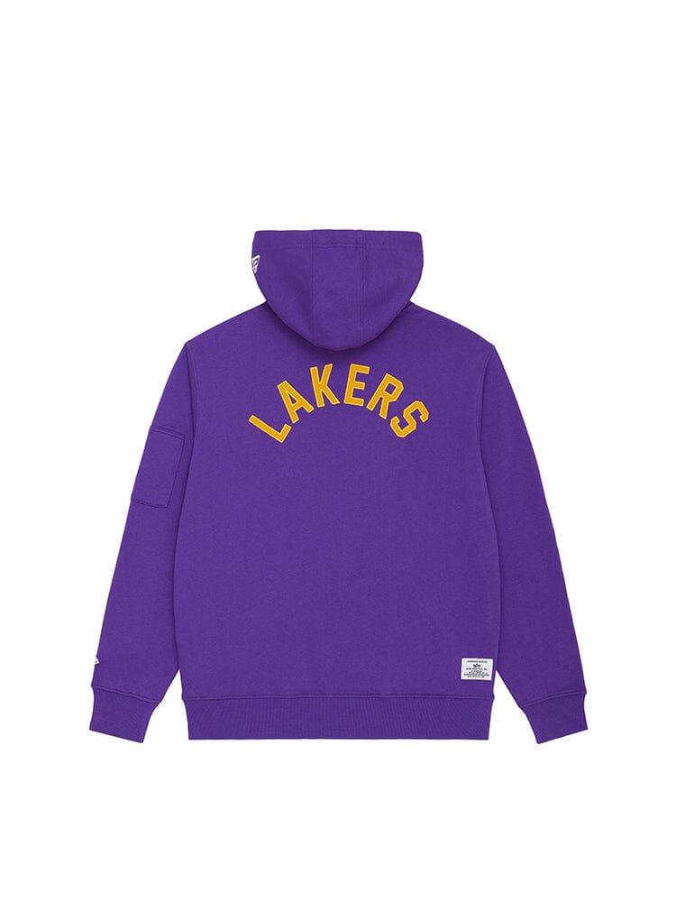 The Los Angeles Lakers X Alpha X New Era Hoodie from Alpha Industries showcases "Lakers" in bold yellow block letters on the back. Made from heavyweight fleece, it features a custom sleeve pocket for added style and functionality.