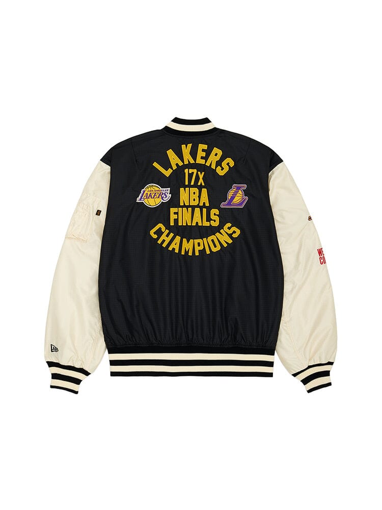 Introducing the Los Angeles Lakers x Alpha x New Era L-2B Bomber Jacket, a stunning piece from Alpha Industries. This black and white bomber jacket showcases "17x NBA Finals Champions" text and iconic team logos on the back. Complementing its sleek exterior, the jacket includes a stylish pinstripe interior and boasts authentic team patches for an added touch of flair.