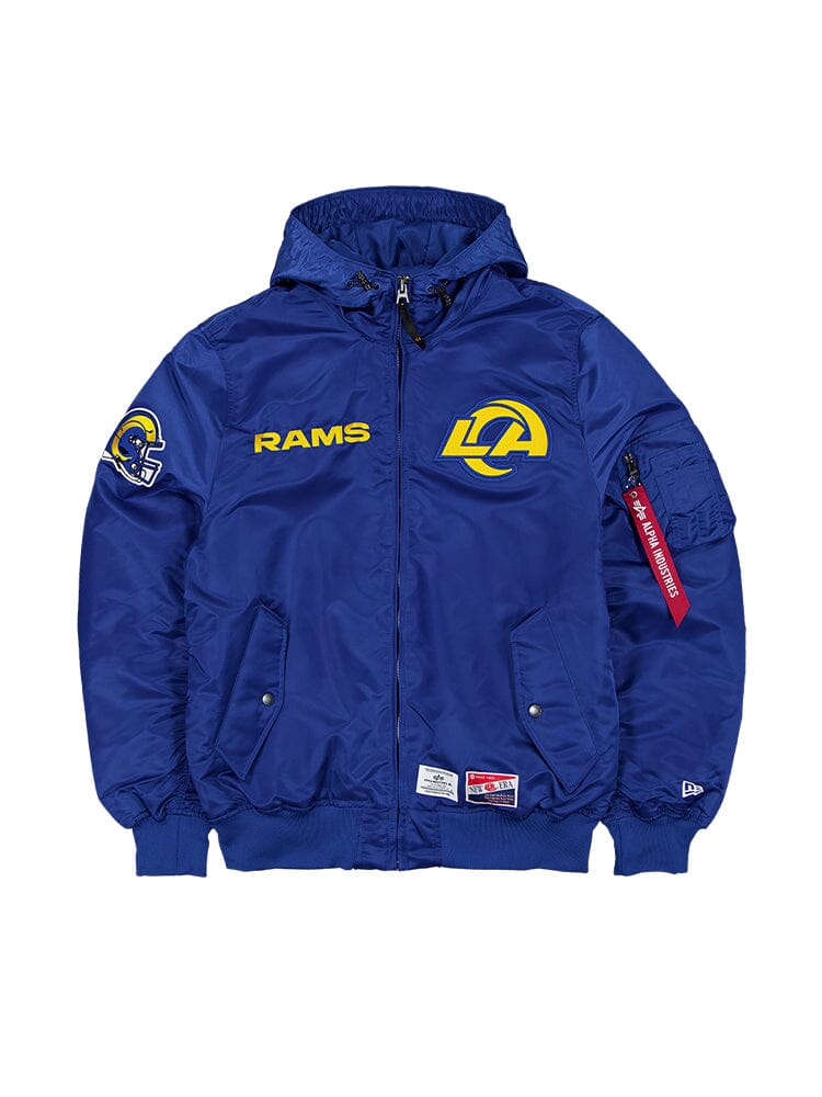 This Pacific Blue Los Angeles Rams L-2B Bomber Jacket from Alpha Industries, designed in collaboration with New Era, features the iconic Rams logo and text on the front. It includes a striking red zipper tag on the sleeve for added flair. This NFL bomber style offers a stylish nod to team pride while ensuring ripstop durability.