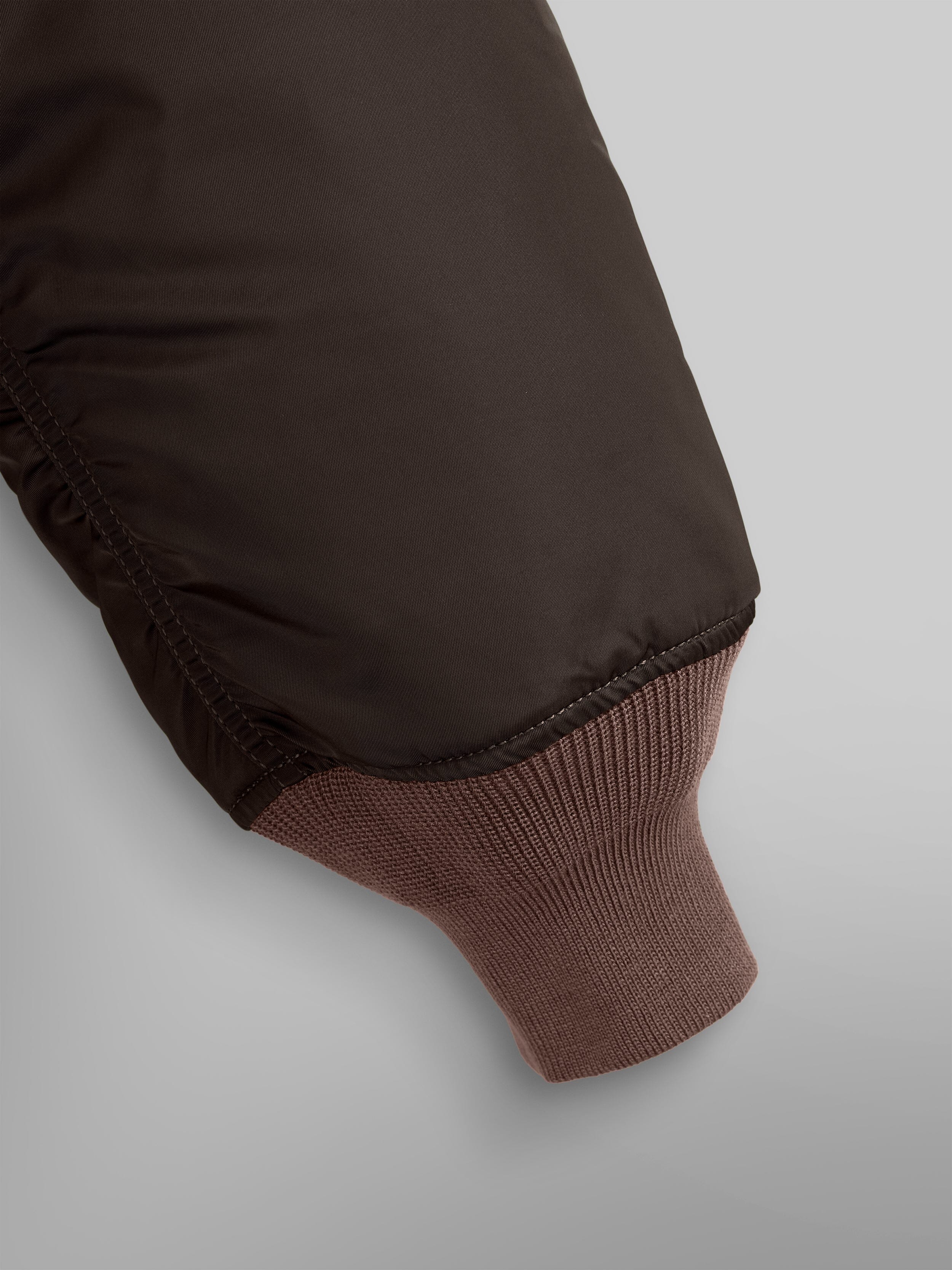 Close up view of MA-1 Bomber Jacket (Heritage) in Dark Brown (Chocolate). Sleeve and ribbed cuff. By Alpha Industries.