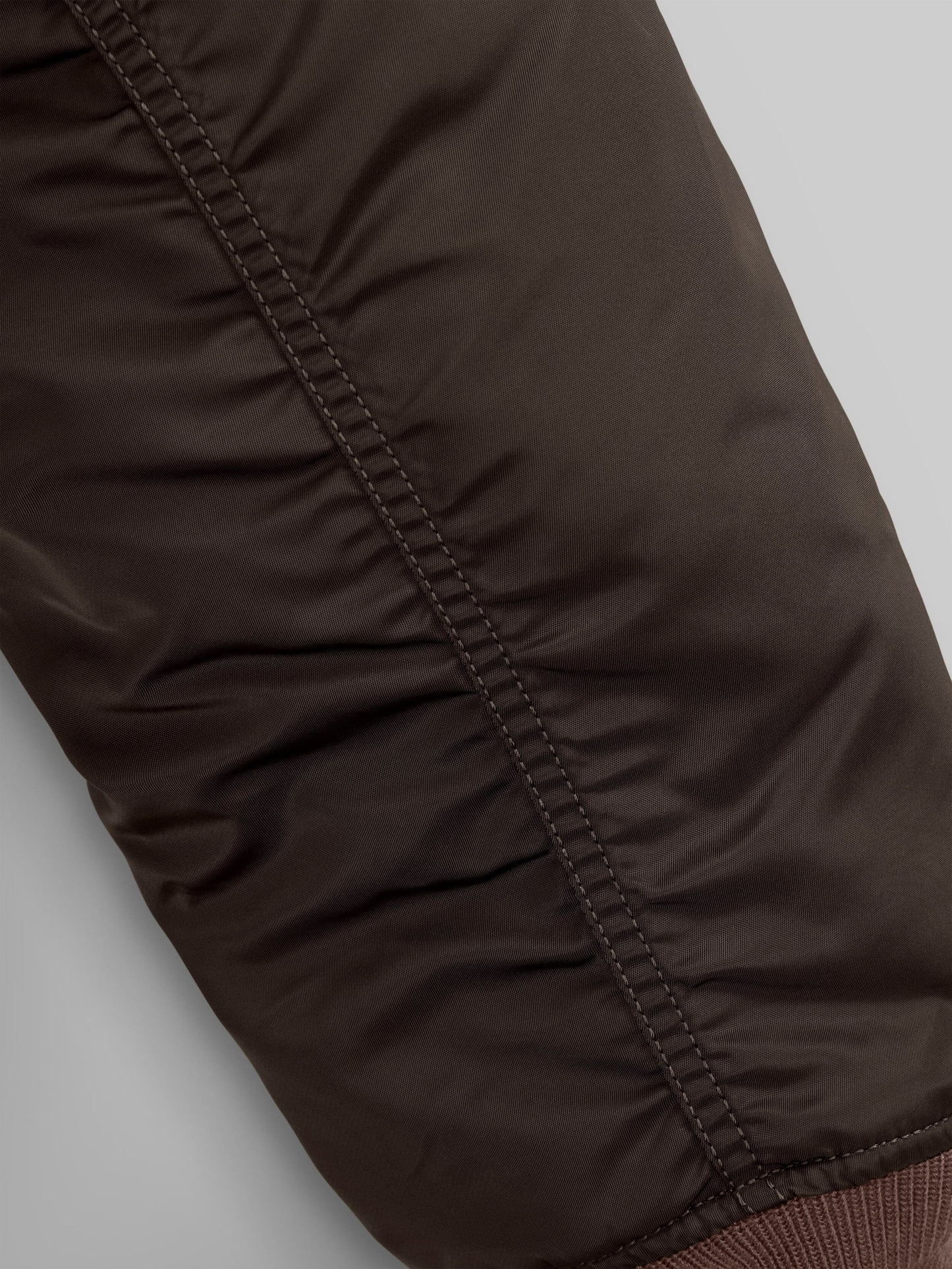 Close up view of MA-1 Bomber Jacket (Heritage) in Dark Brown (Chocolate). Sleeve stiching. By Alpha Industries.