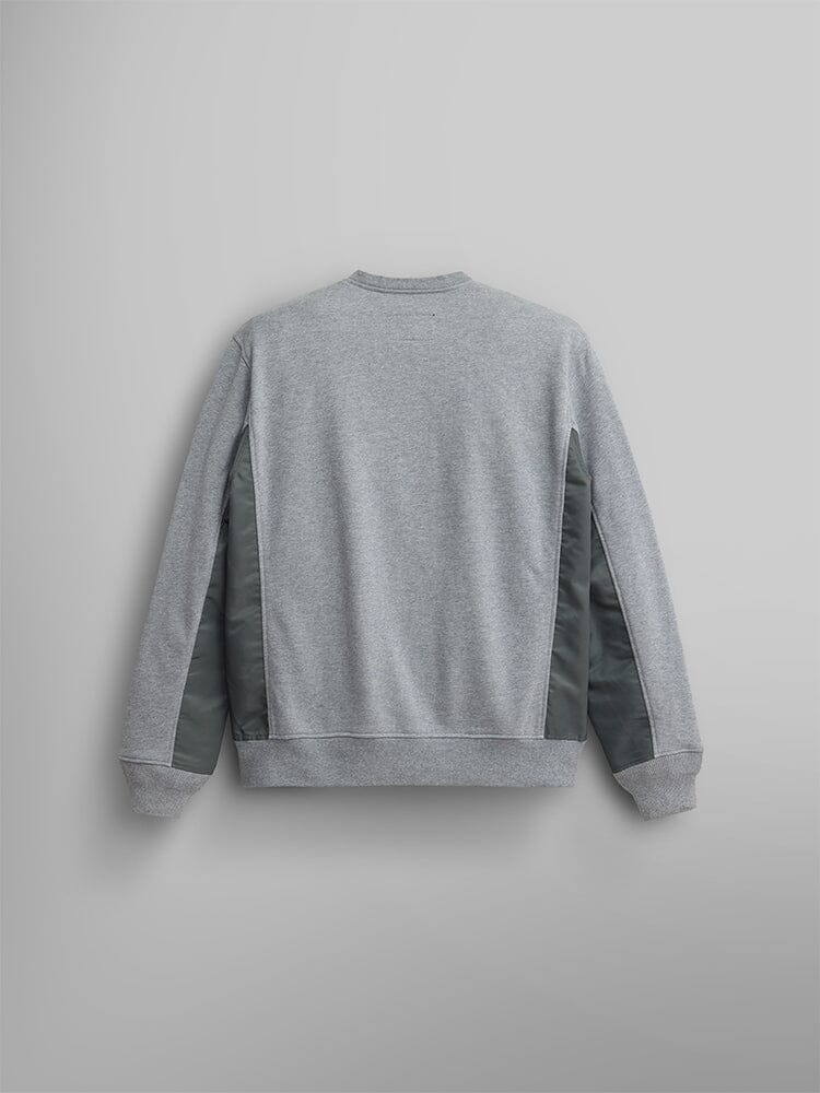 The Alpha Industries Mixed Media Crewneck Sweatshirt in gray is displayed from the back, featuring dark green side panels and nylon patches.