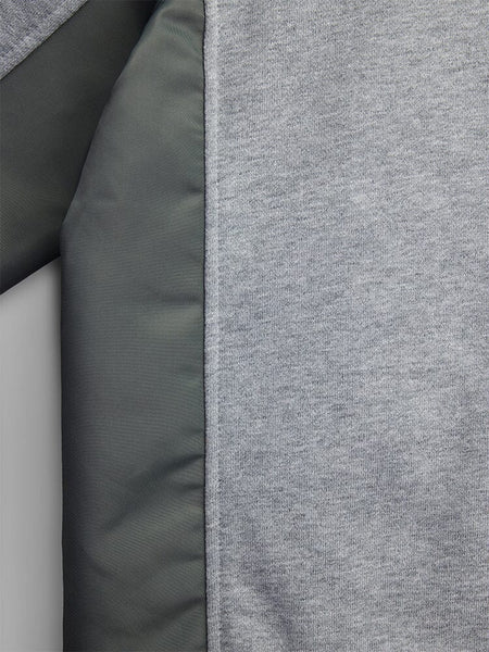 Close-up of the Mixed Media Crewneck Sweatshirt by Alpha Industries, featuring a gray wool-like fabric with a dark green quilted section and accented nylon patches.