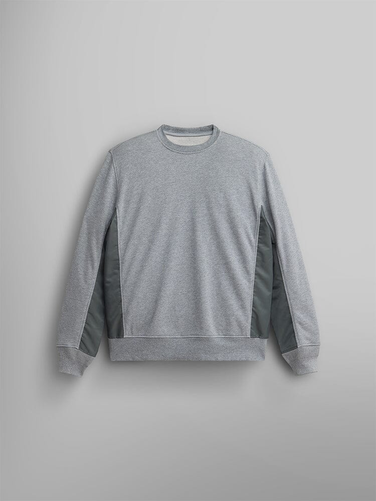 The Mixed Media Crewneck Sweatshirt by Alpha Industries, in Medium Charcoal Heather with darker side panels, is elegantly displayed, highlighting its French terry fabric.