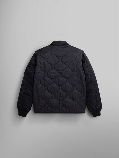 Back view of the Mixed Media Quilted Utility Jacket by Alpha Industries, features a black design with a wavy pattern on the back, made from nylon ripstop material.