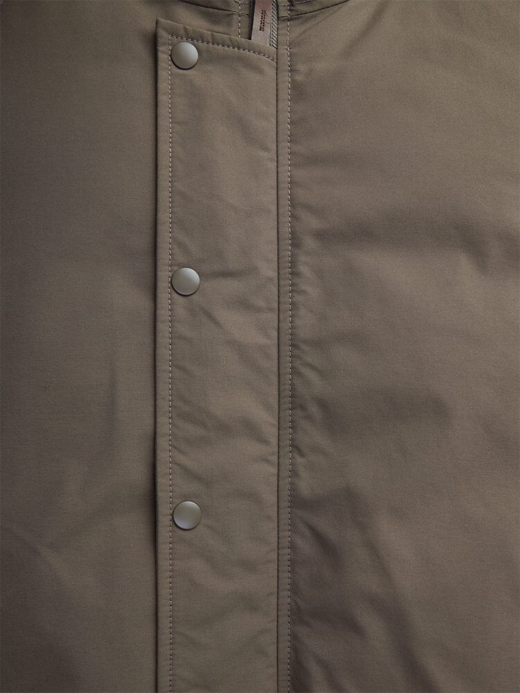 Close-up of the N-2B Altitude Parka by Alpha Industries, in brown with visible snap buttons and stitching detail.