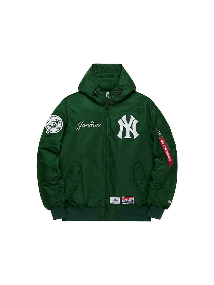 The New York Yankees X Alpha x New Era L-2B Bomber Jacket by Alpha Industries, in green, showcases the Yankees text and logo on the front, accompanied by a hood and patches on the sleeves.