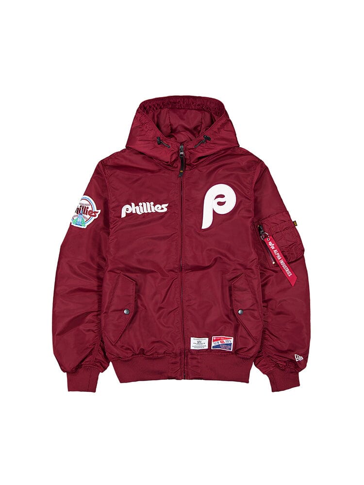 Burgundy Philadelphia Phillies L-2B Bomber Jacket with a Hood, Showcasing MLB Team Logos and Patches on the Front and Sleeves. This Product Is by Alpha Industries, Model FW24-NE-MLB.