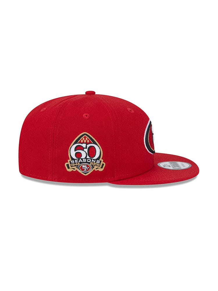 Introducing the San Francisco 49ers X Alpha X New Era 950 Cap, a striking red New Era snapback adorned with a 60 Seasons emblem on the side and a circular team logo on the front, ideal for fans of Alpha Industries.