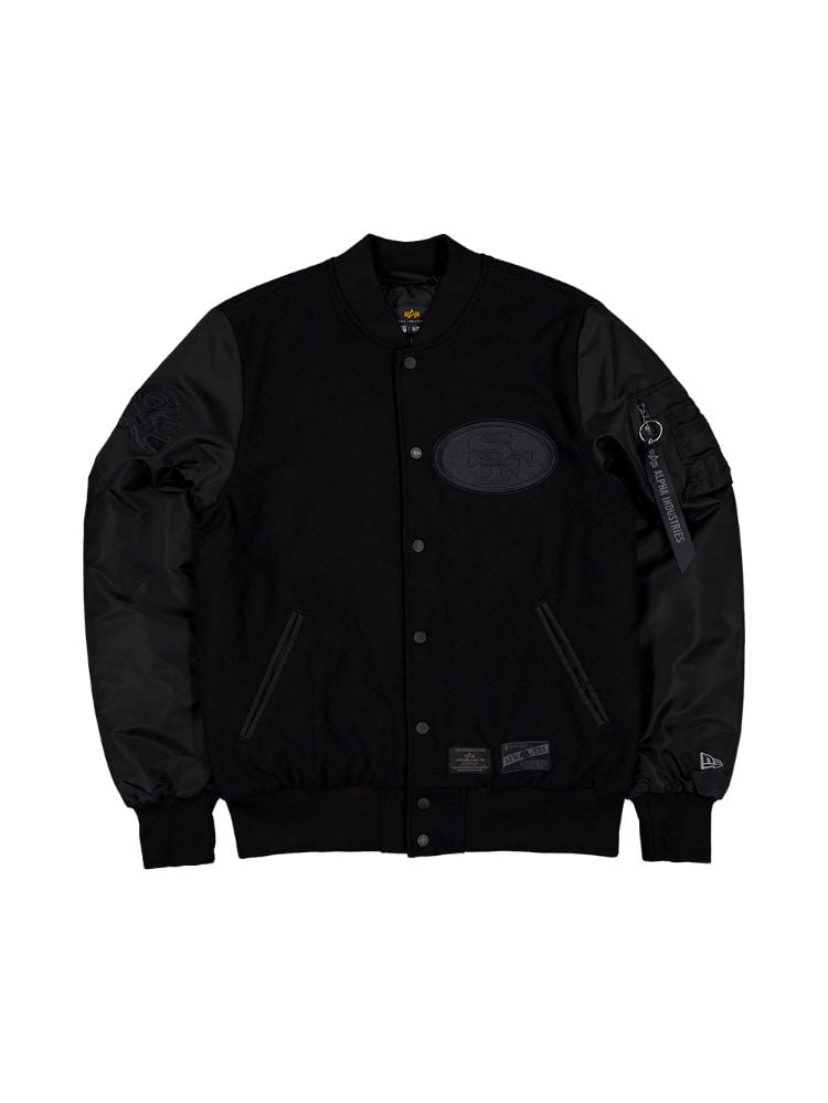 The San Francisco 49ers x Alpha x New Era Wool Varsity MA-1 Bomber Jacket by Alpha Industries showcases a black varsity style with a wool outer shell, button closure, and black faux leather sleeves. It features patch details and a functional pocket on the left sleeve for added convenience.