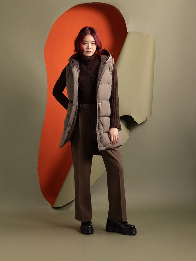 A person with red hair is wearing the Sierra Convertible Jacket W by Alpha Industries, layered over a brown sweater and pants.