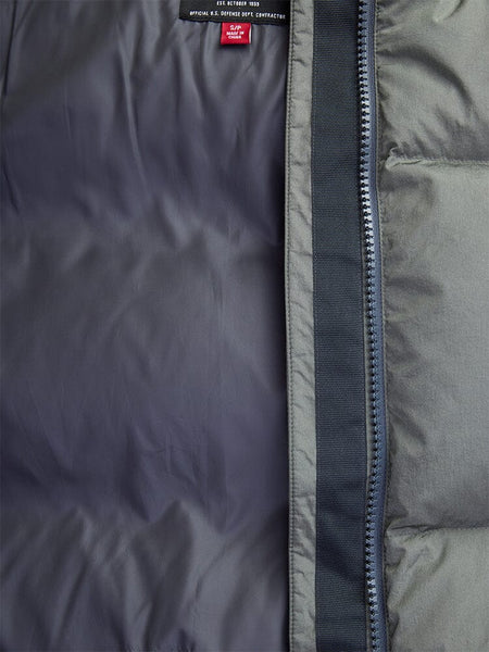 Close-up of a partially unzipped Sierra Short Puffer W by Alpha Industries, highlighting its gray inner lining and durable, water-resistant zipper.