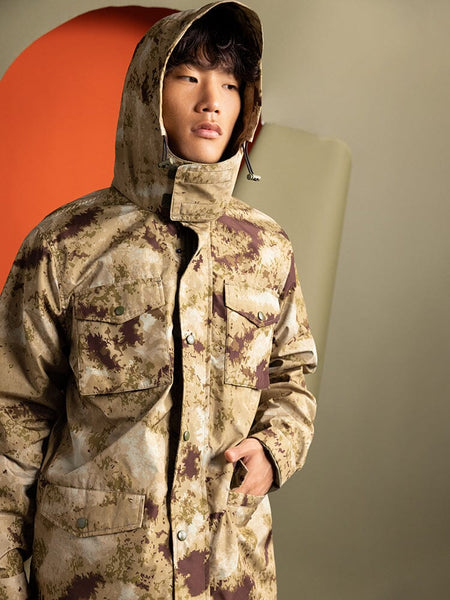 An person wearing an Alpha Industries Tactical M-65 Field Jacket in Green Blur Camo.