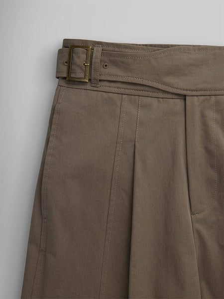 Close-up of the Women's Gurkha Wide Leg Trousers in brown by Alpha Industries, featuring pleats and a brown belt with a brass buckle.