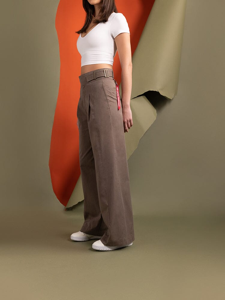 Side-view of a women wearing the Women's Gurkha Wide Leg Trouser in brown by Alpha Industries.