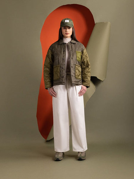 Full body view of a person wearing the Alpha Industries Women's Insulated Chore Coat in green.