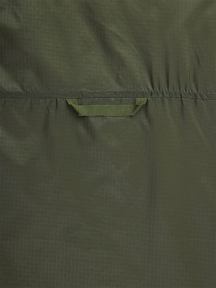 Close-up back view of the Women's Insulated Chore Coat by Alpha Industries, showcasing its green fabric with a horizontal strap, subtle checkered texture, and visible stitching that evokes the look of onion quilting.