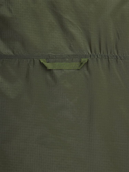 Close-up back view of the Women's Insulated Chore Coat by Alpha Industries, showcasing its green fabric with a horizontal strap, subtle checkered texture, and visible stitching that evokes the look of onion quilting.