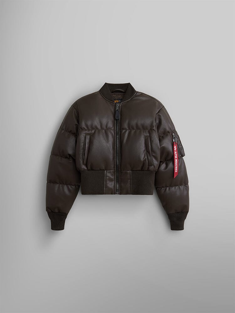 The Women's Sierra Faux Leather Short Puffer Jacket by Alpha Industries, featuring a dark chocolate color, cropped fit, zipper closure, ribbed cuffs and hem, and a distinctive red tag on the sleeve.