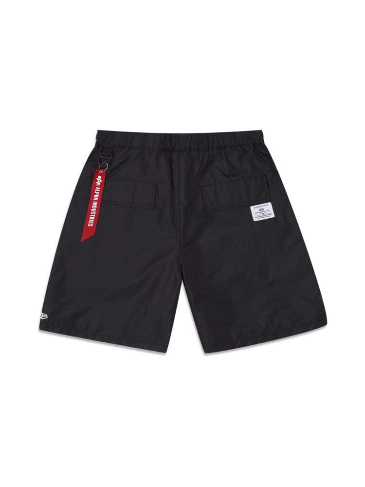 Brooklyn Nets x Alpha x New Era Nylon Shorts by Alpha Industries / NE-NBA are crafted from durable ripstop fabric and feature a distinctive red tag on the waistband. With two back pockets and a white label on the right pocket, they blend style with functionality.