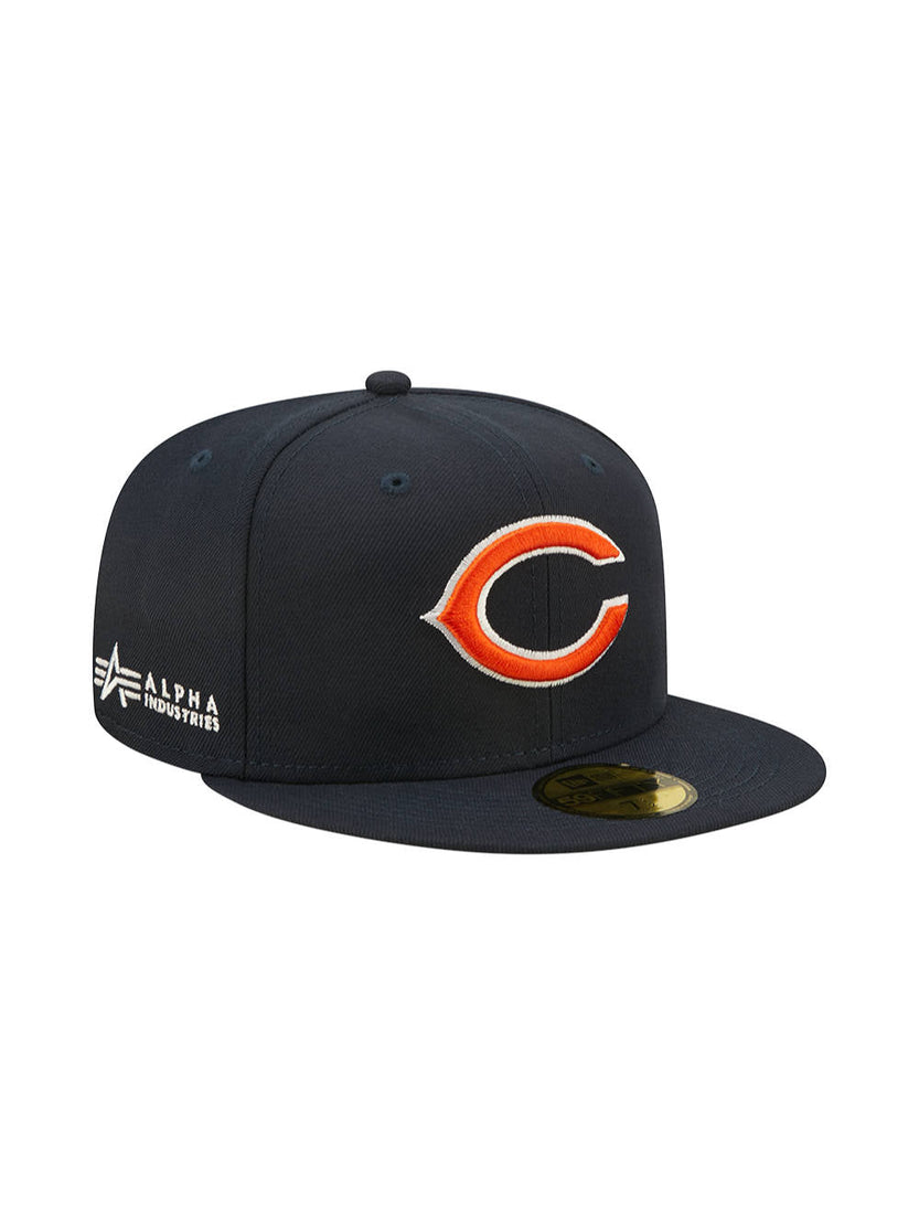 The Chicago Bears x Alpha x New Era 59FIFTY Fitted Cap features a sleek black design with an orange 'C' team logo on the front and the Alpha Industries emblem prominently displayed on the side.