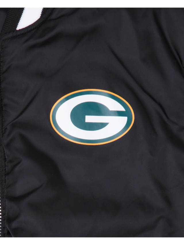 Close-up of the Green Bay Packers X Alpha X New Era MA-1 Bomber Jacket, featuring a prominent green and gold G logo. This chic jacket is part of the exclusive collaboration between Alpha Industries and NE-NFL, highlighting its distinctive design.