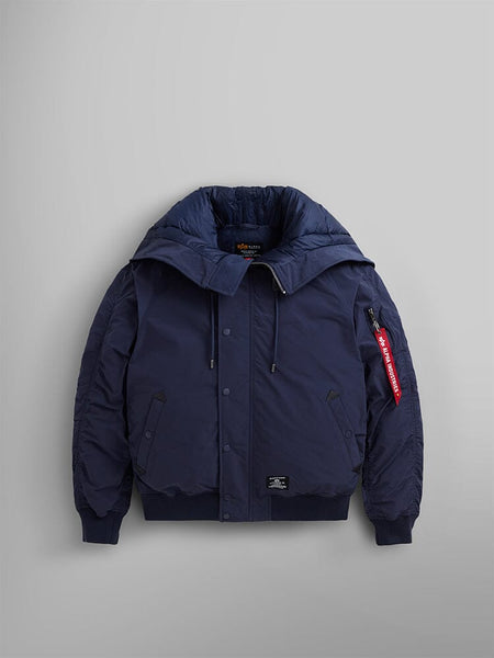 An N-2B Altitude Parka by Alpha Industries in blue, showcasing its water-resistant fabric, detachable adjustable split hood, and a distinctive red tag on the sleeve.