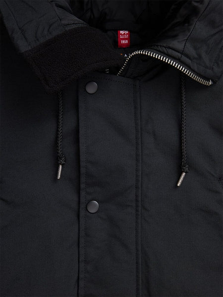 Close-up of the N-3B Altitude Mod Parka by Alpha Industries, a black water-resistant winter coat featuring a zipper, snap buttons, and drawstring hood.