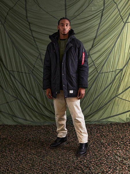 A person wearing an Alpha Industries N-3B Altitude Mod Parka in black.