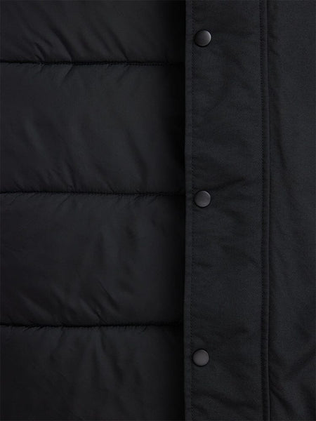 A close-up of the N-3B Altitude Mod Parka by Alpha Industries showcases its dark, quilted fabric with snap button closures on the right side, echoing a mod parka design.