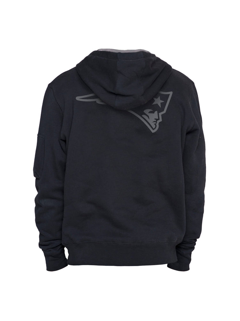 This New England Patriots x Alpha Industries x New Era hoodie is a sleek black design featuring a sports logo on the back, showcasing a stylized face and hat.