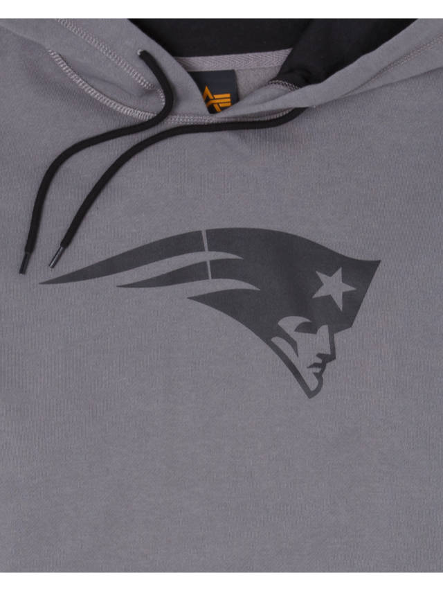 The New England Patriots x Alpha x New Era Hoodie by Alpha Industries is a gray pullover showcasing a stylized logo of a head with a hat and a star design, combining modern flair with classic comfort.