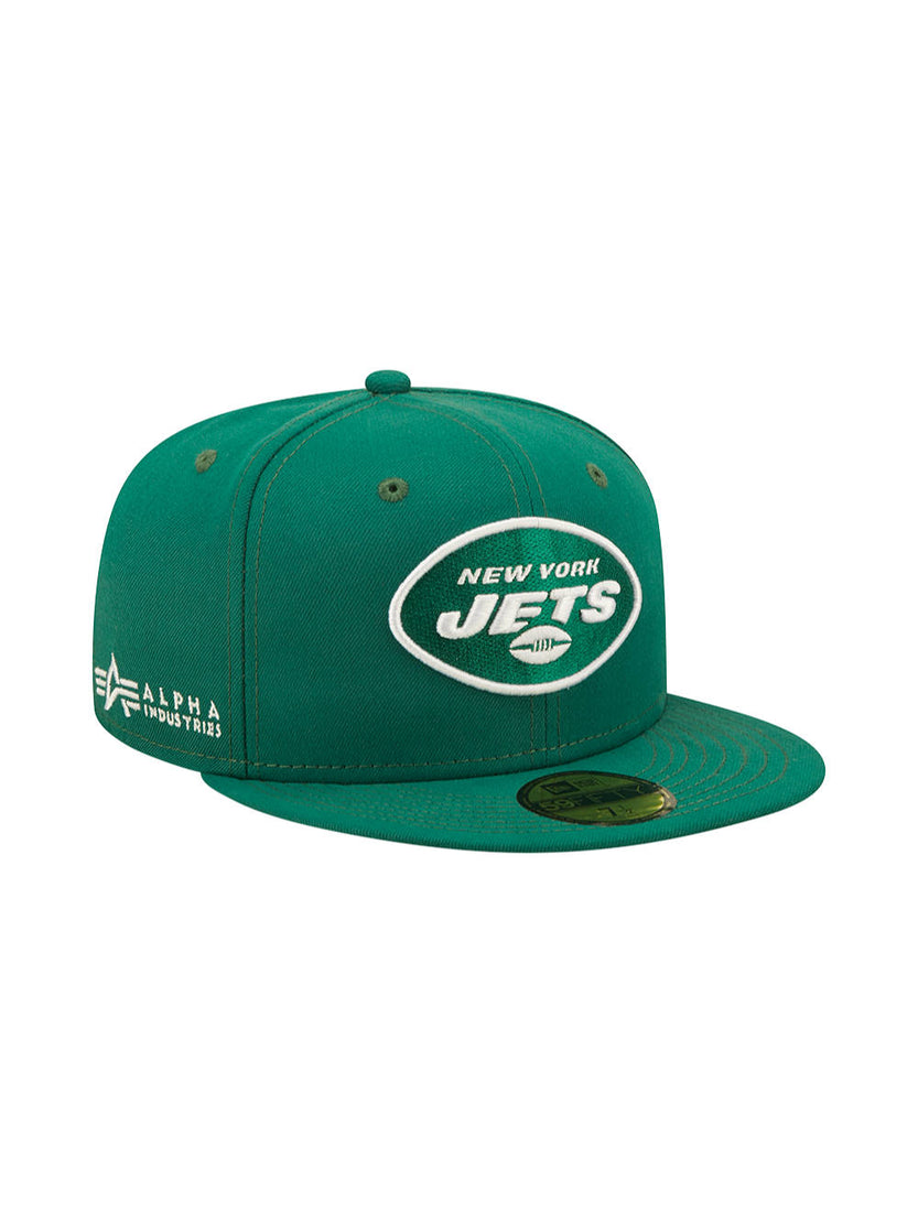 The New York Jets x Alpha x New Era 59Fifty Fitted Cap, by Alpha Industries, is a green cap with an embroidered team logo and "Alpha Industries" text on the side. It features a flat brim and comes with a New Era sticker on the bill.