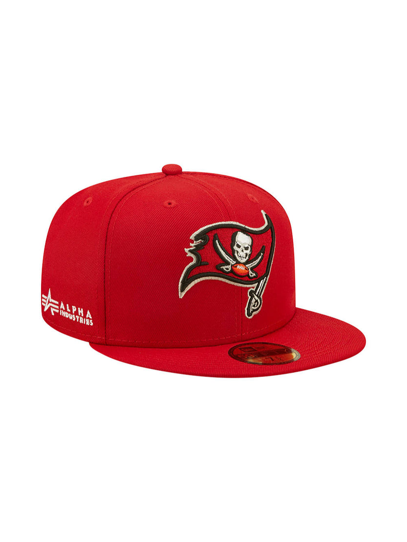 Tampa Bay Buccaneers x Alpha x New Era 59Fifty Fitted Cap in red, featuring an embroidered skull and sabre logo on the front. Alpha Industries text is elegantly stitched on the side, proudly showcasing the collaboration between Alpha Industries and NE-NFL.